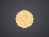a close up of a gold coin on a black background