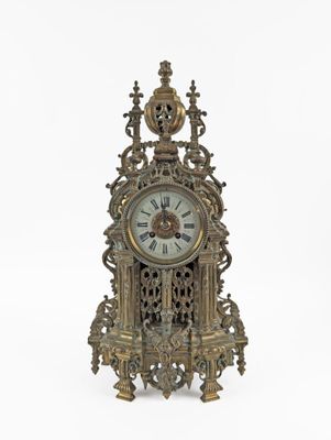 a clock that is sitting on a white surface