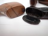 several pairs of shoes are sitting on a table next to a wooden shoe rack
