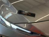 a sticker on the hood of a silver car