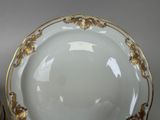 a white plate with gold trim and a bowl with gold trim