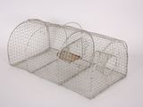 a small metal cage with a piece of wood sticking out of it