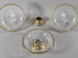 three pieces of glass and brass plate with a candle holder