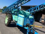 a blue tractor that is parked on the side of the road