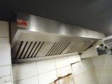 an image of a kitchen with a stove and exhaust hood
