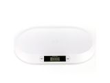 an image of a white electronic clock on a white surface