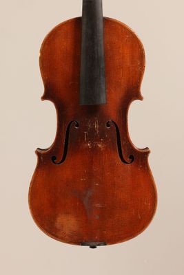 an old violin with a bow hanging from it ' s back