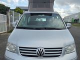 a silver van that is parked on the side of the road