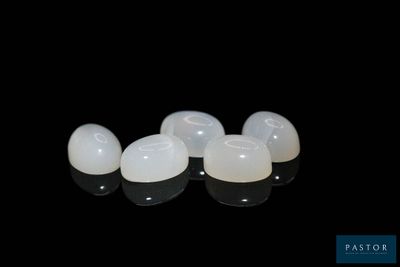 a close up of a pair of implants on a black surface