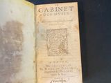 an old book opened to show a picture of a man ' s face