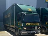 two trucks that are parked in front of a building