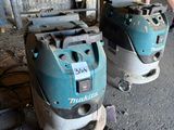 two machines that are sitting on the floor in the room