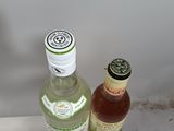 two bottles of alcohol sitting next to each other on a table