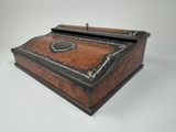 an old wooden box with a black and brown design on it