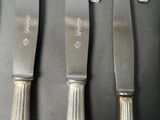 five knives that are sitting on a table