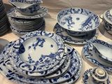 a table with a lot of blue and white plates and bowls