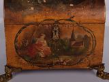 a small wooden box with a painting on it