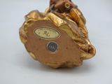 a gold figurine of a man riding a horse