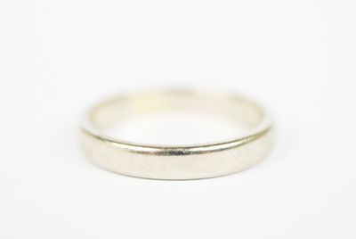 a close up of a silver ring on a white surface