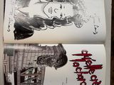 an open book with a drawing of a woman on it