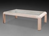 an image of a coffee table with a glass top and wooden legs