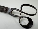 an old pair of scissors on a white surface