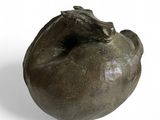 sculpture of a frog on a pomegranate on a white background