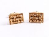 a pair of gold cufflinks with squares and squares on them