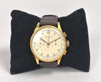 a watch that is sitting on top of a pillow