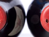 pair of black and red salt and pepper shakers on a white surface