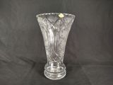 a clear glass vase with a yellow flower in it