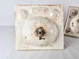 a small white plate with a flower design on it and a small white plate with a flower design on it