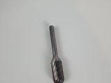 a close up of a small metal tool on a white surface