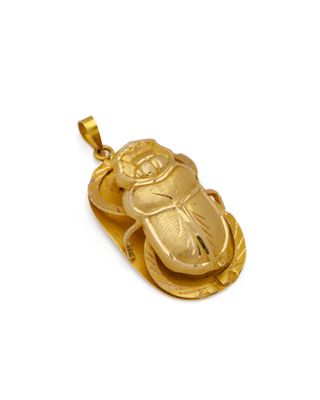 une image représentant un pendentif en forme de scarabée plaqué or sur fond blanc