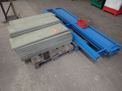 several pieces of steel sit on a pallet in a warehouse