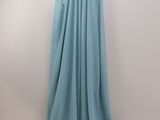 the back of a dress hanging on a hanger on a wall