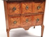 a small wooden chest of drawers with marble top