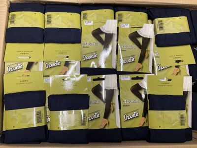 several pairs of socks are packed in a box on a table