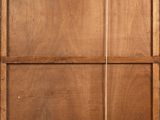 an old wooden cabinet with a mirror on the wall