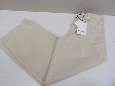 the pants are beige and have a tag on them