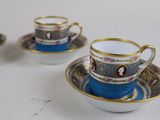 three cups and saucers are sitting on a white surface