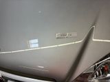 a close up of a car ' s hood with a number plate on it