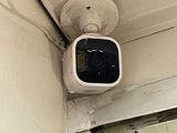 an image of a security camera mounted on the side of a building