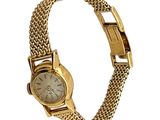 une photo d'une montre-bracelet pour femme avec un bracelet en or