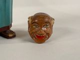 a small statue of a man with a big smile on his face
