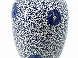 a blue and white vase with a flower design on it