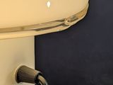 a cream colored toaster with a black handle on it