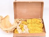 a box with a bunch of yellow yarn inside of it