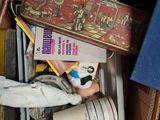 a cardboard box filled with books and other items