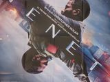 movie poster of a man holding a gun in front of a city